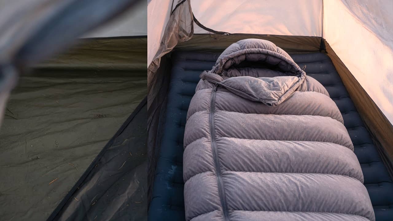 A frosted grey sleeping bag unzipped on a pad in the right half of a tent, darker empty floor on the left